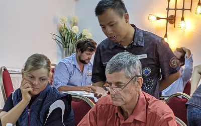 Stacey Haucke, of Byweren, and Jon Haucke, of Heidelberg, get tuition from Department of Resources' David Lin at the Maps & Apps workshop held in Collinsville, and hosted by NQ Dry Tropics' Landholders Driving Change project.