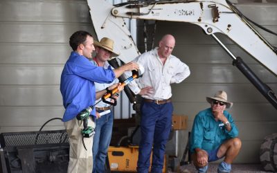 LDC's Rodger Walker demonstrates the applicator that inserts capsules that contain biological control fungi into the tree trunk through a drilled hole. The hole is then sealed with a plug.