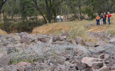Inspecting erosion repair works at Emohruo that included the widening of a dam by-wash and installation of a rock chute to improve surface water management.