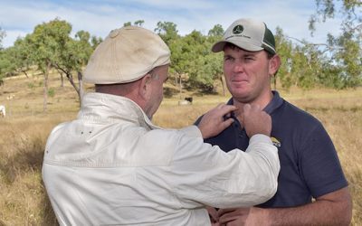 Videographer Michael Beroun adjusts the lapel microphone on LDC Grazing Team Leader Brendan Smith during filming at Riverview Station.