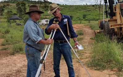Darryl Hill shows Old Hidden Valley grazier Steve Plath how to work a dumpy level
