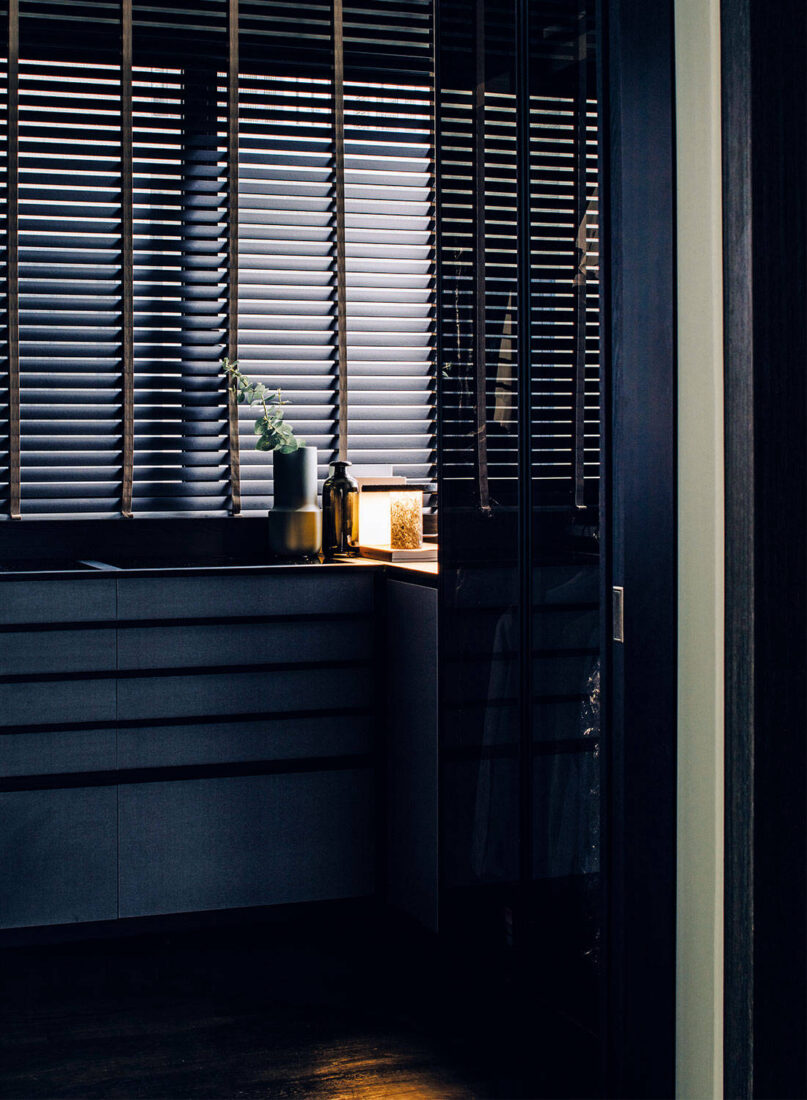 Throughout the apartment, multiple shades of black were created through a play on lighting to present a different visual experience from every viewpoint. A customised feature wall with niches placed at irregular heights add a playful randomness while displaying small art pieces.