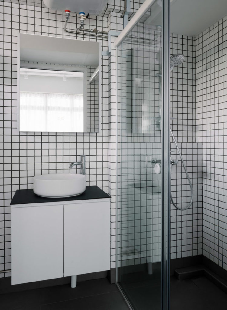 white mosaic bathroom in two-room flat