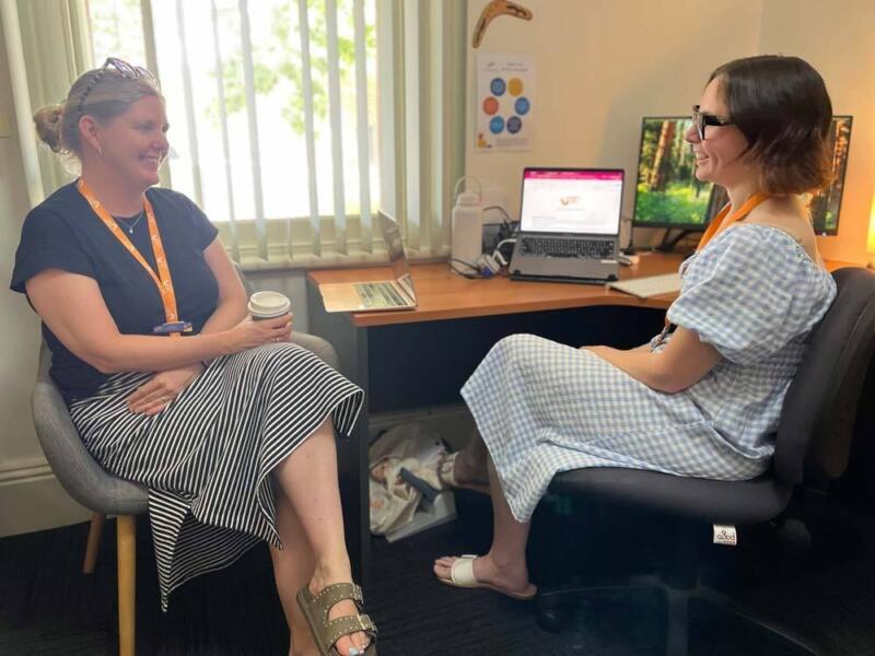 Two Noah's Ark therapists sit at a desk and discuss supervision and mentoring.