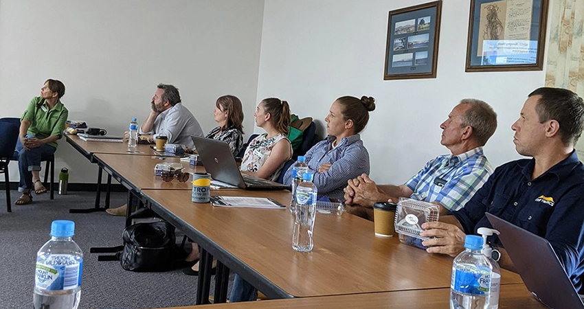 People in a meeting room. Click top open the Governance and Guidance story.