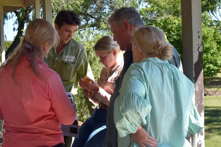NQ Dry Tropics Senior Project Officer Jaymie Rains (left) chats with the Cook family during morning tea.
