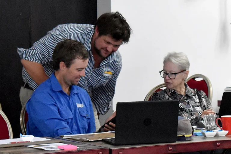NQ Dry Tropics Senior Grazing Field Officer Brad Martin (centre) helps Tim Close and Thelma Powell, Warrigal Station, with Avenza maps.