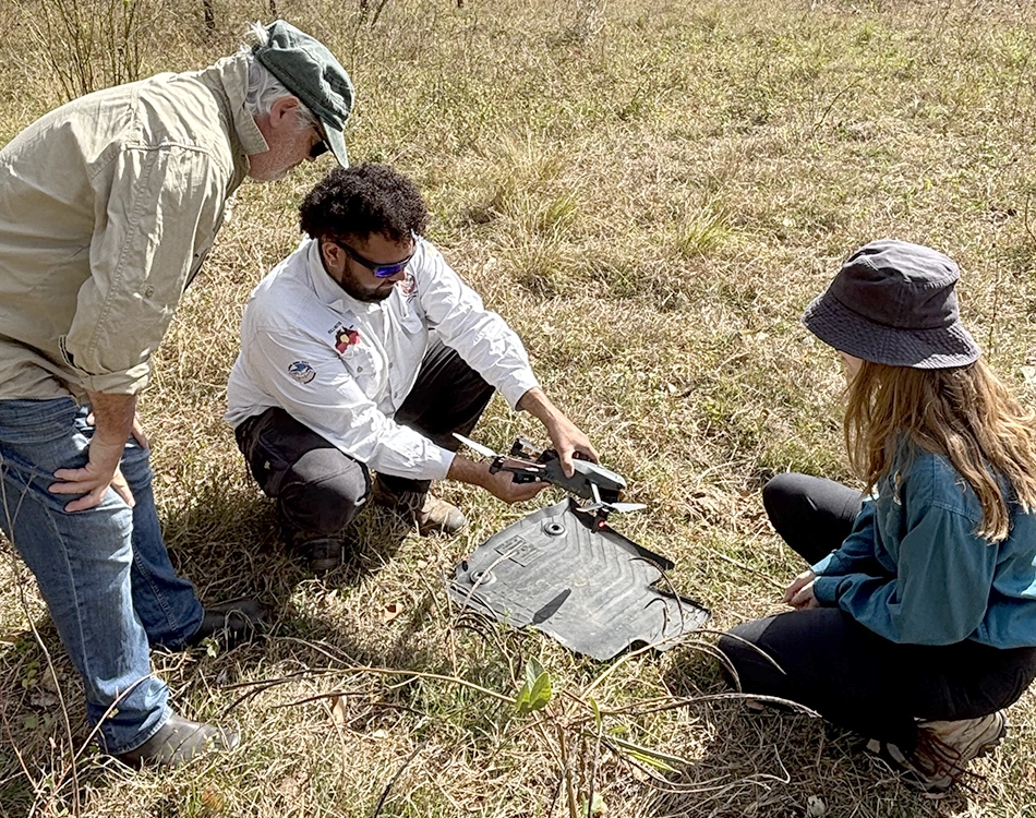 Gudjuda Land and Sea Ranger Rullington Zaro prepares a drone before flying it.
