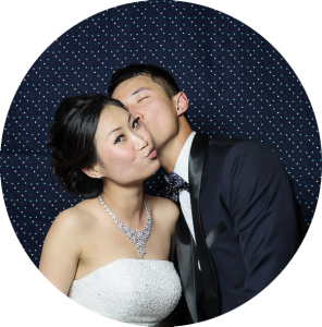 Bride and Groom in Photo Booth with Navy Backdrop