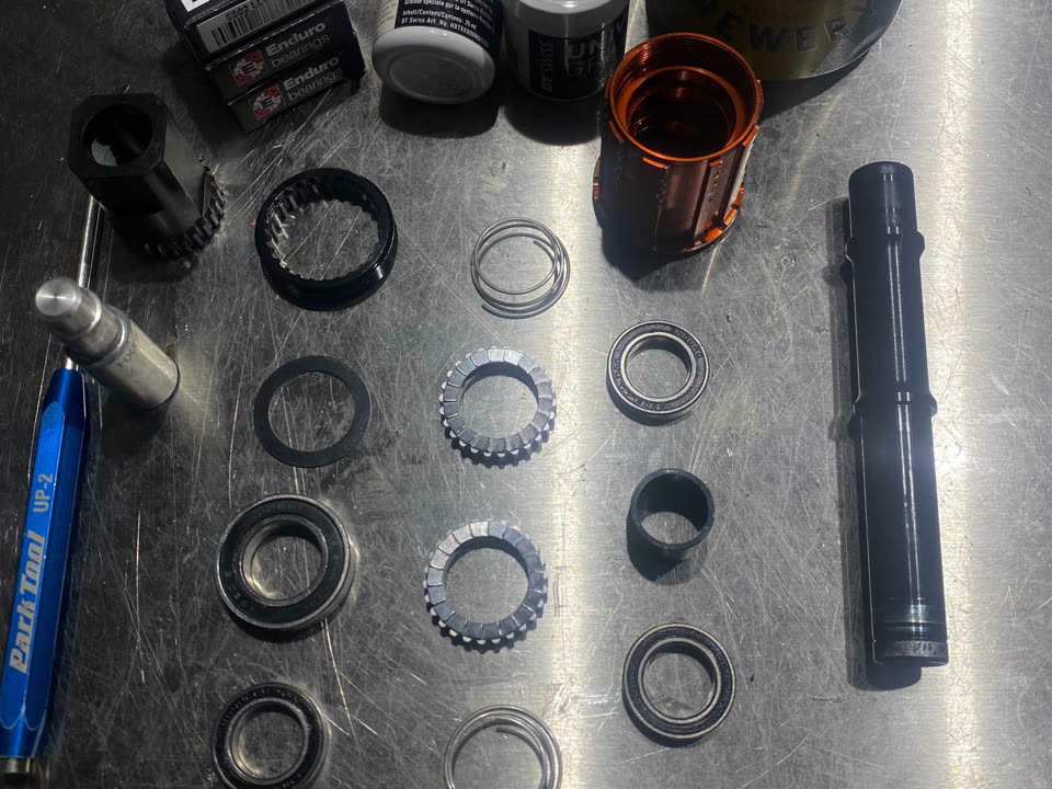 Hub parts laid out on the workbench during a hub service at the Marrickville workshop