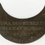 A dull brass crescent with engraved words