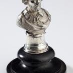 A silver bust of a person with facial hair