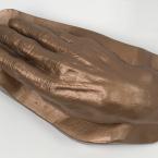 A bronze coloured cast of a hand