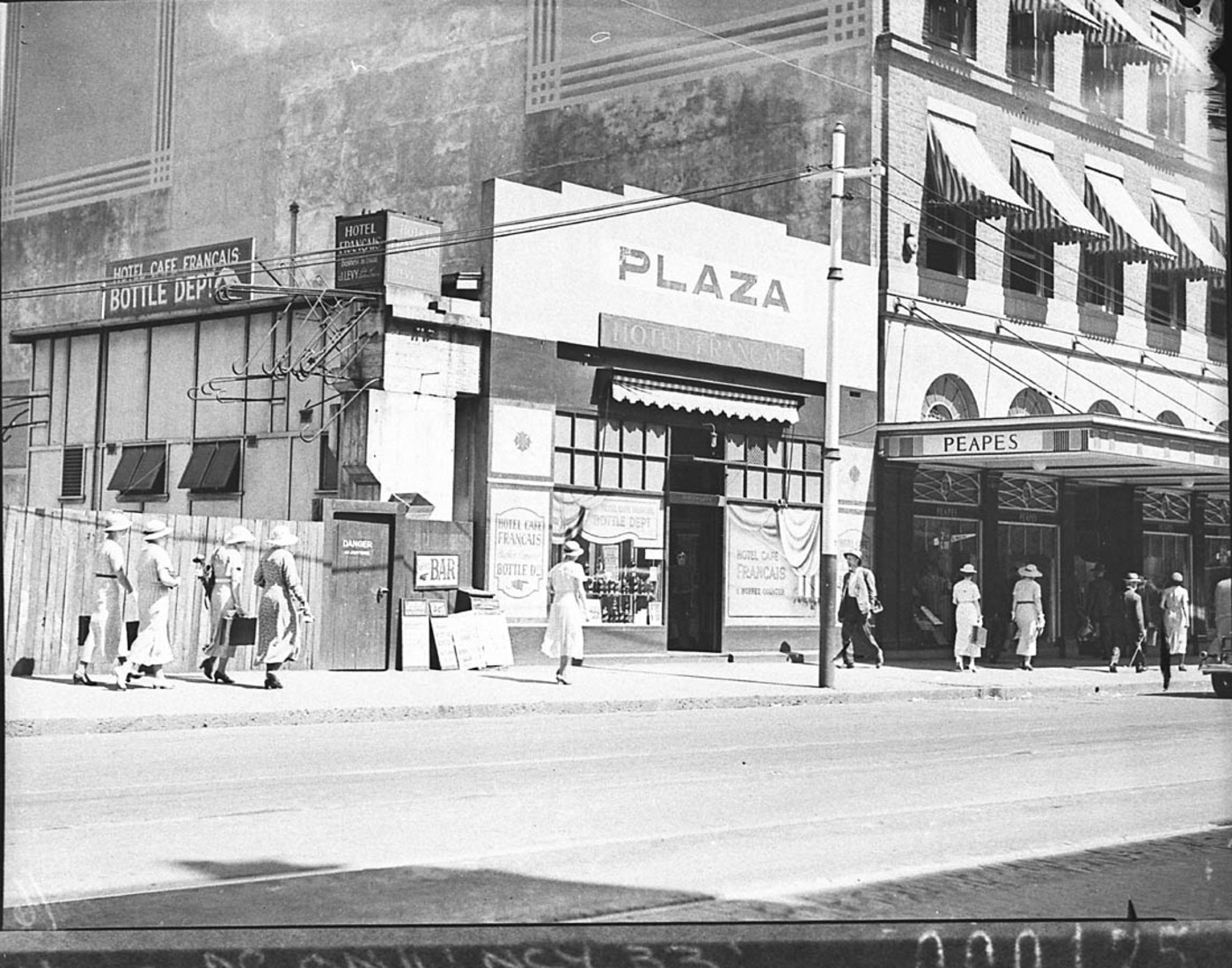 Plaza Hotel temporary bar and Peapes' Menswear Store next door January 1935, by Sam Hood, courtesy Mitchell Library, State Library of NSW (Home and Away 11785)