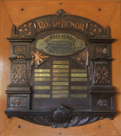 Photograph provided by Graham Wilson, 2016 This timber and brass honour roll has 19 brass plaques with the names of Dundee men who served between 1914 and 1918. The roll features carvings of the Bristish and Australian flags, swords and small canons.