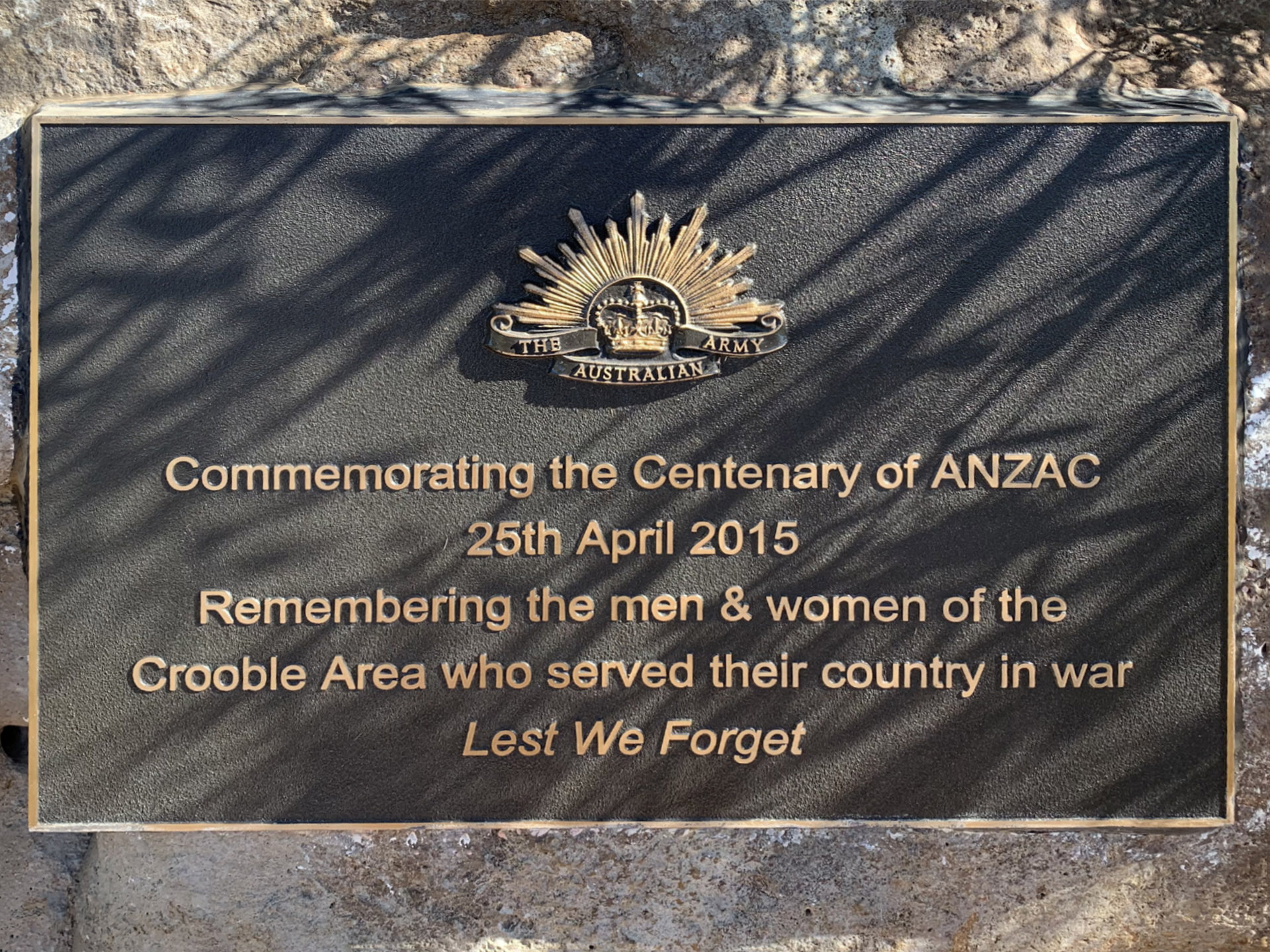 Close-up of plaque on bushrock in Crooble War Memorial Hall Memorial Garden