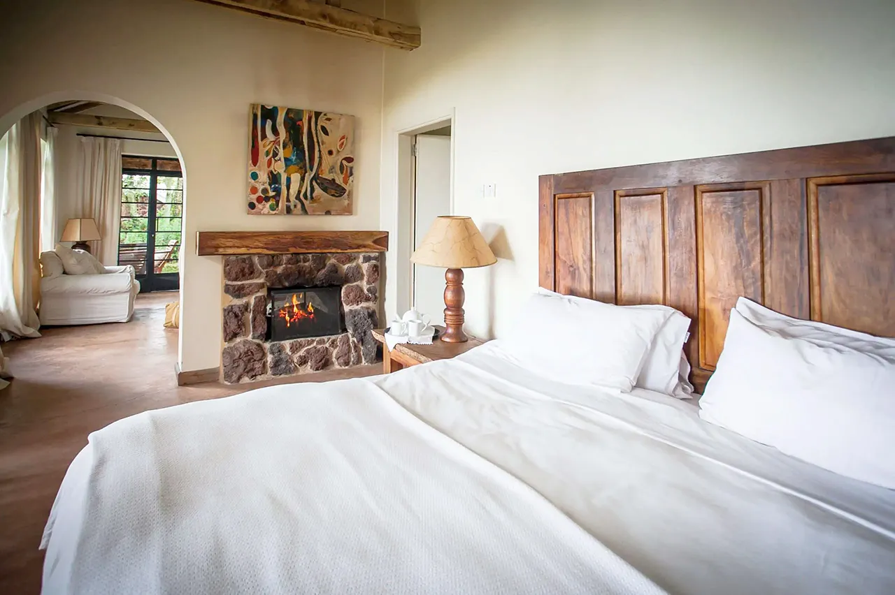 Clouds Mountain Gorilla Lodge, Bwindi Impenetrable Forest, Uganda, Cottage, Bedroom and Fireplace