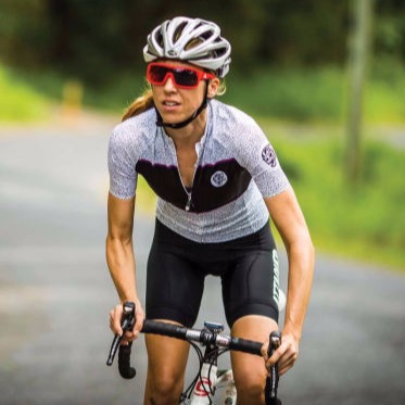 Mobile bike mechanic performing a flat tyre repair on a road bike at a customer's location