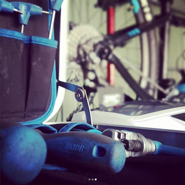 Qualified bike mechanic performing a professional service